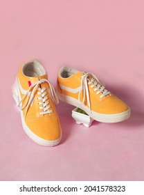 Plain Yellow Converse Sneakers Isolated On A Bright Background Are Very Popular Among Teenagers. A Simple Shoe Model That Is Perfect For School Or For Fashion. Free Space For Your Ad. Shoe Mockup.