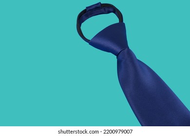 A Plain Zipper Neck Tie With Tie Knot Close Up View With Plain Background, A Pre Tied Necktie Isolated On Pale Blue Color Backdrop 