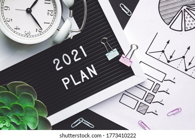 Plan For 2021. Alarm Clock And Office Accessories On The Table Top View.