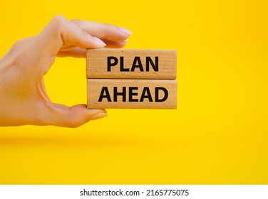 Plan Ahead Symbol. Wooden Blocks With Words 'Plan Ahead'. Beautiful Yellow Background. Businessman Hand. Business And 'Plan Ahead' Concept. Copy Space