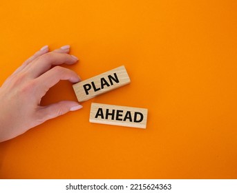 Plan Ahead Symbol. Wooden Blocks With Words Plan Ahead. Beautiful Orange Background. Businessman Hand. Business And Plan Ahead Concept. Copy Space.