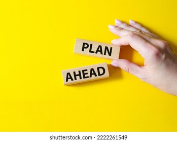 Plan Ahead Symbol. Wooden Blocks With Words 'Plan Ahead'. Beautiful Yellow Background. Businessman Hand. Business And 'Plan Ahead' Concept. Copy Space.