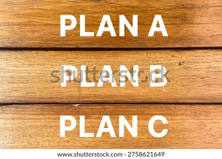 Plan A Plan B Plan C text on wooden background representing decision making, alternative strategy, and business planning concept.