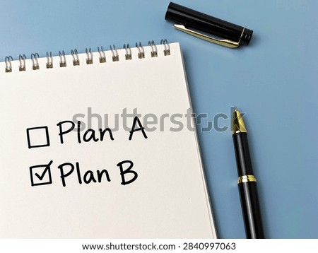 Plan B Selected with Check Mark in Notebook on Blue Background Representing Backup Strategy, Alternative Choice and Business Planning. 
