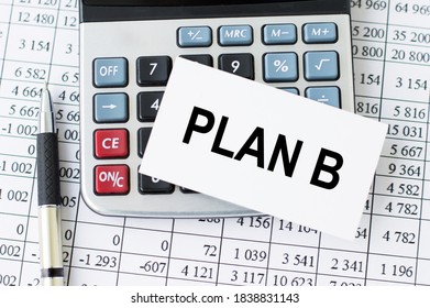 PLAN B Word On A Card On The Desktop On A Calculator, A Pen And Financial Reports. Business Concept