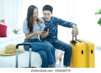 Plan Vacation Trip Holiday. Loving Couple Searching Information On Mobile Phone And Booking. Young Asian Man And Women Are Preparing For The Journey Happily.