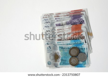 A plan view of isolated used sterling notes and coins.