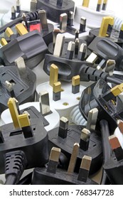 plan view of plugs – Blurred background of  three pin plugs with top of plug  with test sticker
