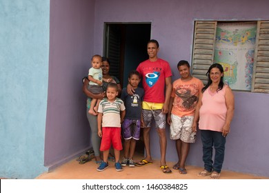 Planaltina, Goiás, Brazil-April 28, 2018: A Family Of Seven Standing Out In Front Of Their Newly Remodeled Home In The Poor Community Of Planaltina