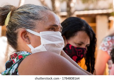 Planaltina, Goias, Brazil-July 25 2020: A Woman Wearing A Protective Mask While Waiting For Food At A Distribution Center For The Poor Of The Community