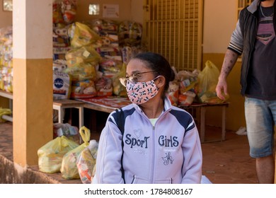 Planaltina, Goias, Brazil-July 25 2020: A Woman Wearing A Protective Mask While Waiting For Food At A Distribution Center For The Poor Of The Community