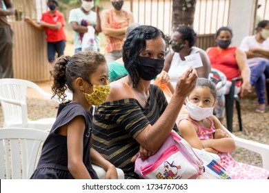 Planaltina, Goias, Brazil-May 16th 2020: A Woman With Her Two Kids At A Local Feeding Center Waiting For For To Be Distributed 