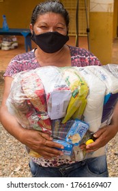 Planaltina, Goias, Brazil-May 16th 2020: A Local Feeding Center In Planaltina, Hands Out Food And Clothing To The Poor People Of The Community While Everyone Wear Their Protective Surgical Mask.