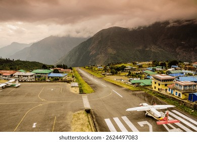 Plane about to take off between mountains, Lukla Airport, Sagarmatha National Park, Nepal, Asia