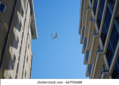 Plane between buildings