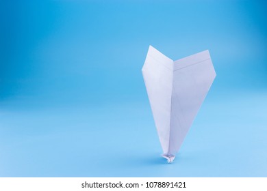 Plane Crash Concept. Paper Plane Upside Down On Blue Background