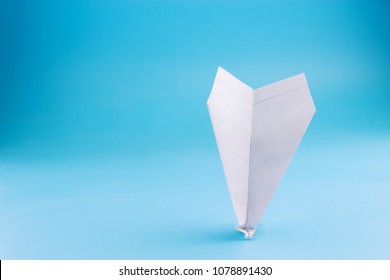 Plane Crash Concept. Paper Plane Upside Down On Blue Background