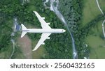 plane flies above the landscape. Side view of aircraft. Travel and transportation concept.