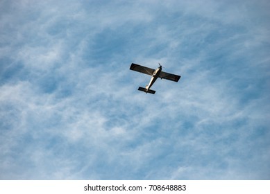 The plane flies against the background of clouds