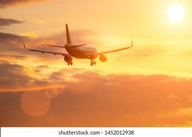 plane flies in sky towards sun. - Shutterstock ID 1452012938