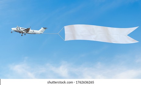 Plane flies in the sky with a white banner for ad. 
