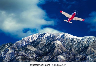 Plane in flight over snow capped mountains.