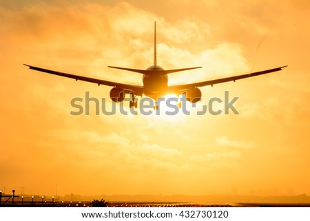 Plane is flying to the airport during a foggy sunrise. Nice vortex behind the wings of the airplane.