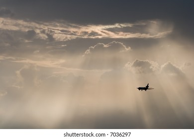 A Plane Flying Away In The Evening Sky