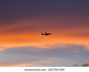 Plane flying into a cloud in the sunset