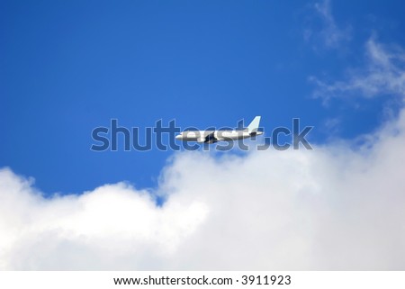 Plane flying overhead with a blue sky background