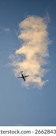A plane is flying through a cloudless sky. The sky is blue and t