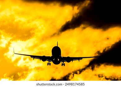 A plane is flying through a cloudy sky with a yellow sunset in the background. Concept of adventure and freedom, as the plane soars through the sky above the clouds