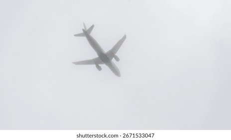 A plane is flying through a cloudy sky. The sky is overcast and the plane is low to the ground