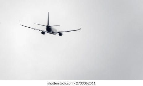 A plane is flying through a cloudy sky