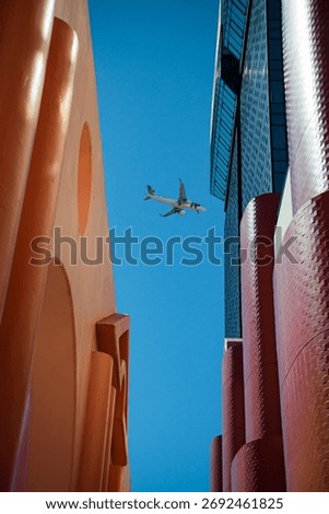 Plane framed between components of the Amoreiras shopping center, in Lisbon. A postmodernism building arrchitecture