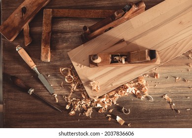 Plane jointer carpenter or joiner tool and wood shavings. Woodworking tools on wooden table. Carpentry workshop - Shutterstock ID 2037836606