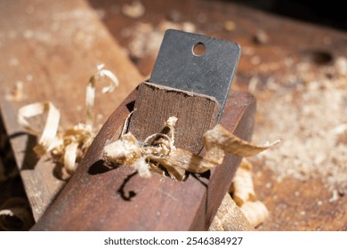 Plane jointer carpenter or joiner tool and wood shavings. Woodworking tools wooden table. Carpentry workshop - Powered by Shutterstock