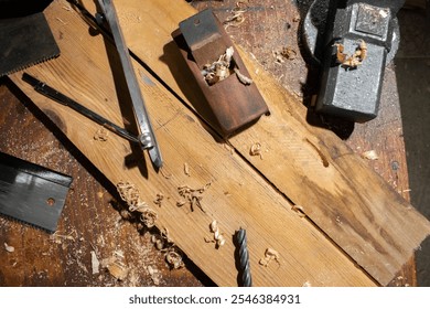 Plane jointer carpenter or joiner tool and wood shavings. Woodworking tools wooden table. Carpentry workshop - Powered by Shutterstock