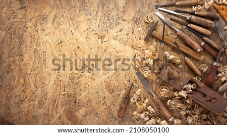 Plane jointer carpenter or joiner tool and wood shavings. Woodworking tools at wooden table
