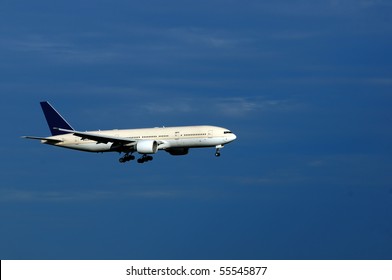 An Plane With Landing Gears Switched On And Ready To Land