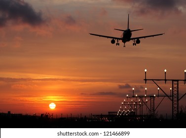 Plane Landing In A Sunset. Back Light