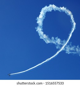 Plane making a looping in an empty blue sky