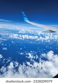 plane in the middle of the clouds inside the blue sky