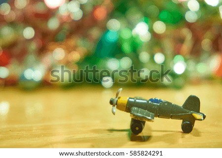                                The plane on wooden table with colorful bokeh light background