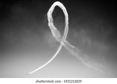 A Plane Paints A Ribbon In The Sky With Smoke