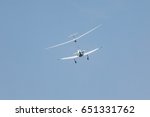 Plane pulling of a glider, white small sports plane pulls a glider into the cloud
