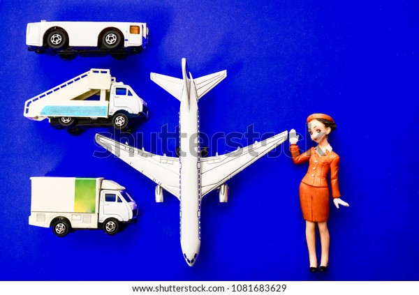 plane, stewardess, truck with baggage and\
aircraft gangway on blue paper\
background