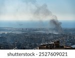 A plane taking off from Beirut International Airport as smoke rises from airstrike on Beirut southern suburbs, amid ongoing war between Hezbollah and Israel in October 2024