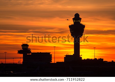 Plane taking off from Schiphol international airport at sunset. Amsterdam, The Netherlands