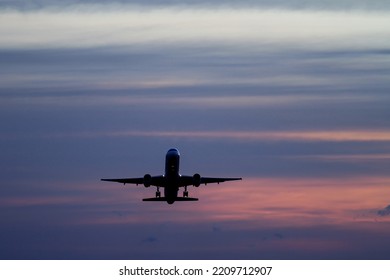 plane taking off at sunset